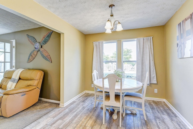 209 N Wilmington Ln, Lafayette, IN 47905 - dining room with light wood-style flooring, a textured ceiling, and a chandelier