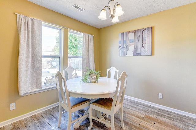 209 N Wilmington Ln, Lafayette, IN 47905 - dining space featuring a chandelier, wood finished floors, and a textured ceiling