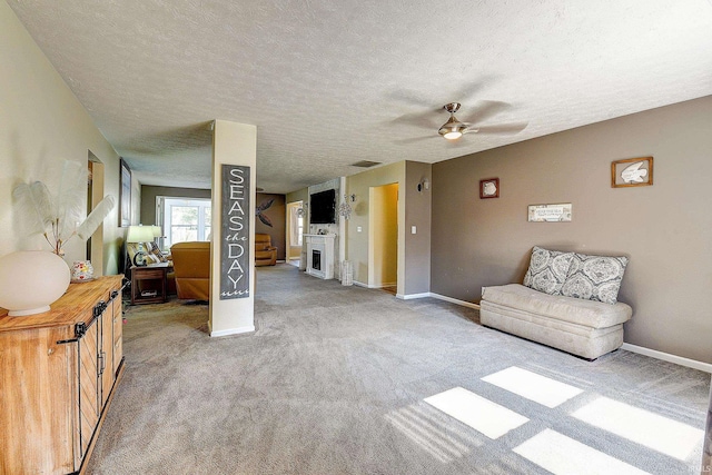 209 N Wilmington Ln, Lafayette, IN 47905 - living room featuring ceiling fan, light colored carpet, a textured ceiling, and a fireplace