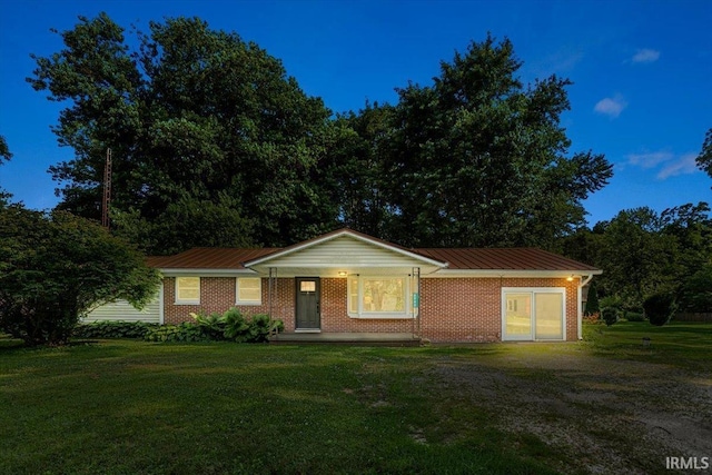 6943 Main St, West Point, IN 47992 - ranch-style house with a front lawn, a metal roof, a porch, and brick siding