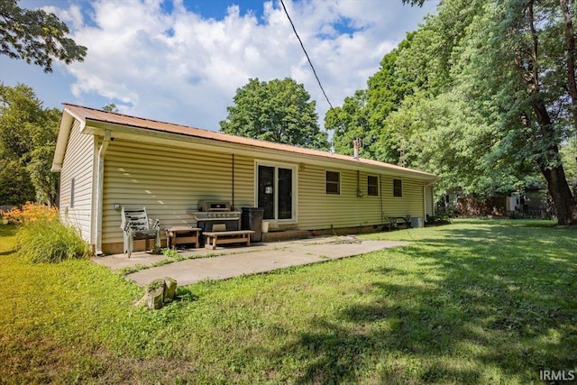 6943 Main St, West Point, IN 47992 - back of property featuring a yard, a patio, and a metal roof