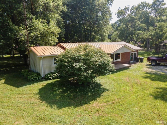 6943 Main St, West Point, IN 47992 - view of front of home featuring a standing seam roof, a front lawn, and a metal roof