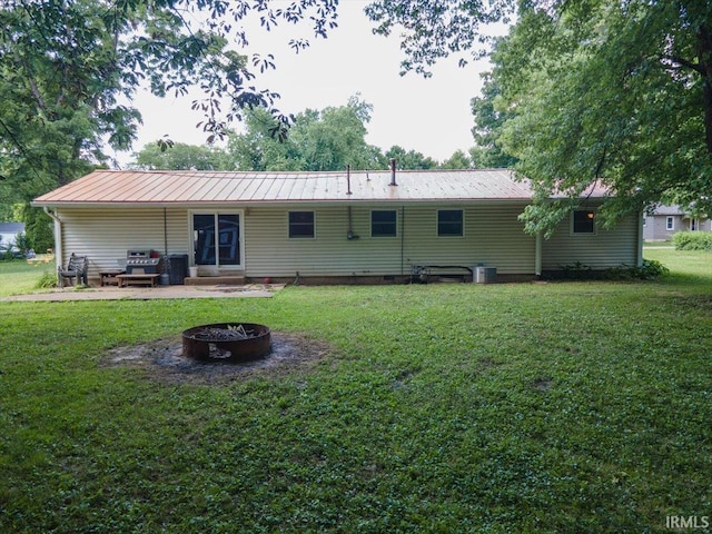 6943 Main St, West Point, IN 47992 - rear view of property with an outdoor fire pit, a lawn, a metal roof, a patio, and a standing seam roof