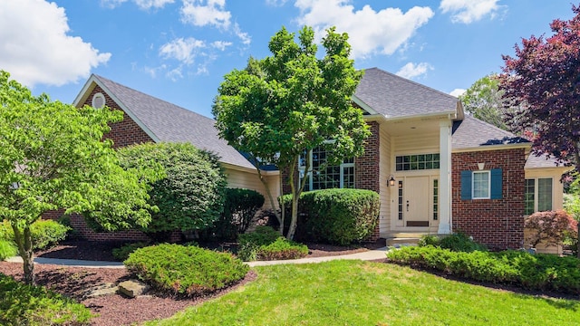 7415 Witling Blvd, Roanoke, IN 46783 - view of front of house featuring brick siding, a front yard, and a shingled roof