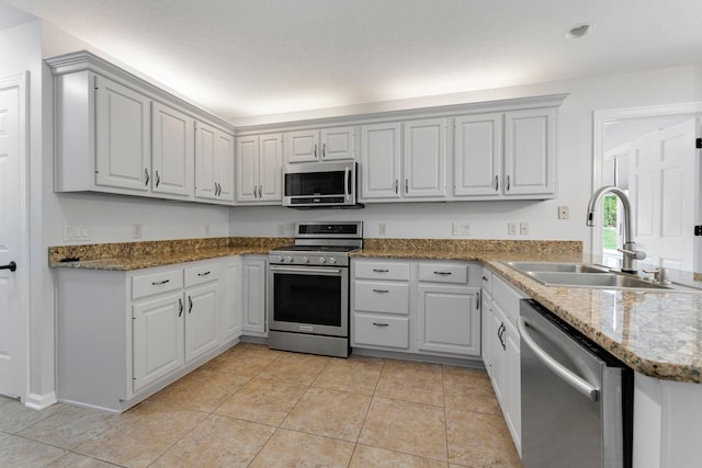 7415 Witling Blvd, Roanoke, IN 46783 - kitchen featuring appliances with stainless steel finishes, light tile patterned flooring, and light stone countertops