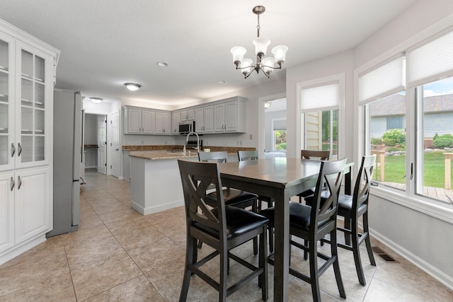 7415 Witling Blvd, Roanoke, IN 46783 - dining space featuring light tile patterned floors, healthy amount of natural light, and a chandelier