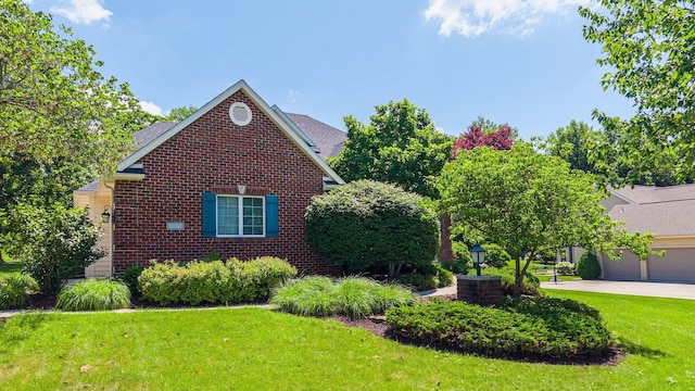 7415 Witling Blvd, Roanoke, IN 46783 - view of property exterior featuring a lawn, brick siding, and a garage