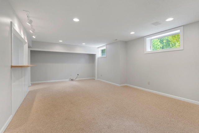 7415 Witling Blvd, Roanoke, IN 46783 - below grade area with light carpet, track lighting, recessed lighting, and healthy amount of natural light
