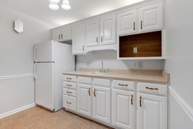 7415 Witling Blvd, Roanoke, IN 46783 - kitchen with freestanding refrigerator, white cabinets, light countertops, and light tile patterned floors