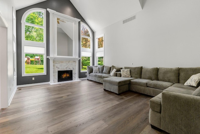 7415 Witling Blvd, Roanoke, IN 46783 - living area featuring healthy amount of natural light, high vaulted ceiling, a fireplace, and wood finished floors