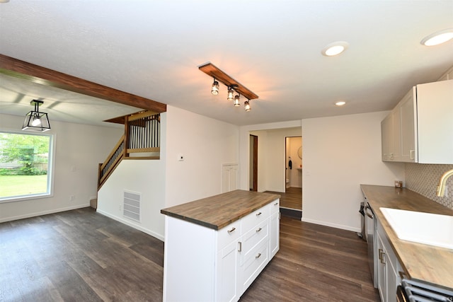 719 N Hathaway St, Winamac, IN 46996 - kitchen featuring wooden counters, dark wood-style flooring, white cabinets, backsplash, and recessed lighting