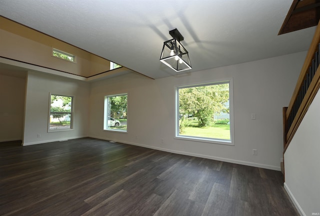 719 N Hathaway St, Winamac, IN 46996 - unfurnished room featuring dark wood-style flooring and stairway