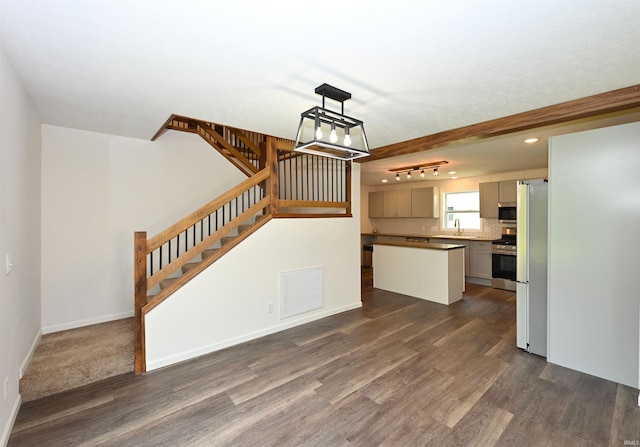 719 N Hathaway St, Winamac, IN 46996 - unfurnished living room with dark wood-style flooring, stairway, and recessed lighting