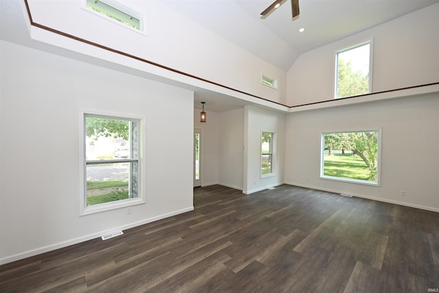 719 N Hathaway St, Winamac, IN 46996 - unfurnished room featuring a ceiling fan, a high ceiling, healthy amount of natural light, and dark wood finished floors