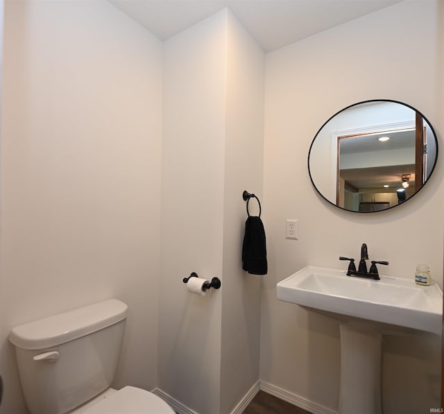 719 N Hathaway St, Winamac, IN 46996 - bathroom featuring toilet and baseboards