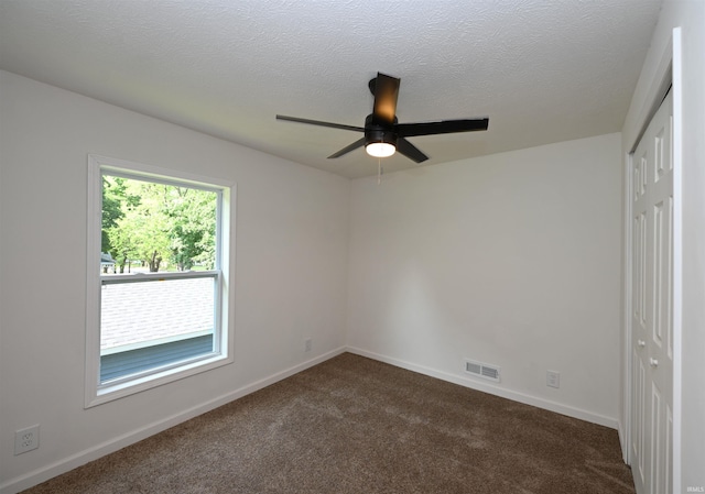 719 N Hathaway St, Winamac, IN 46996 - spare room with ceiling fan and dark carpet