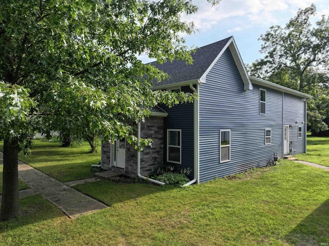 719 N Hathaway St, Winamac, IN 46996 - view of home's exterior with a lawn and a shingled roof