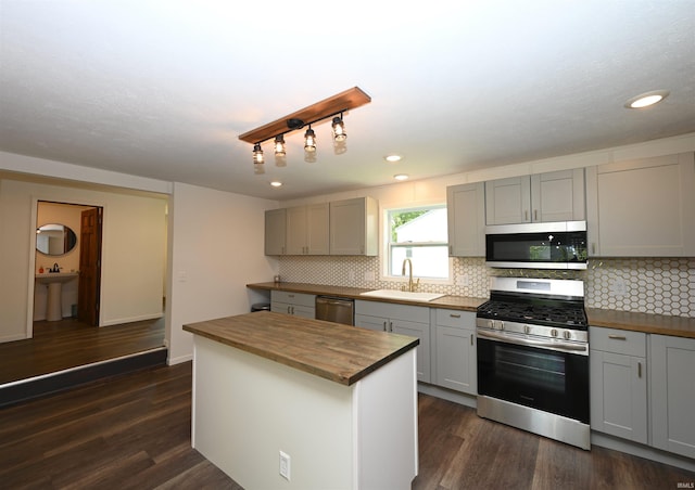 719 N Hathaway St, Winamac, IN 46996 - kitchen with appliances with stainless steel finishes, wood counters, gray cabinetry, dark wood finished floors, and recessed lighting