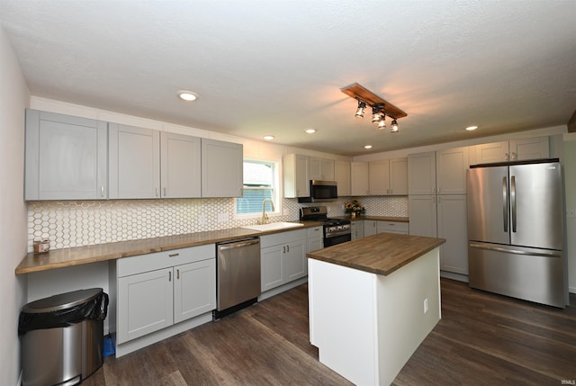719 N Hathaway St, Winamac, IN 46996 - kitchen featuring appliances with stainless steel finishes, wooden counters, dark wood-type flooring, backsplash, and recessed lighting