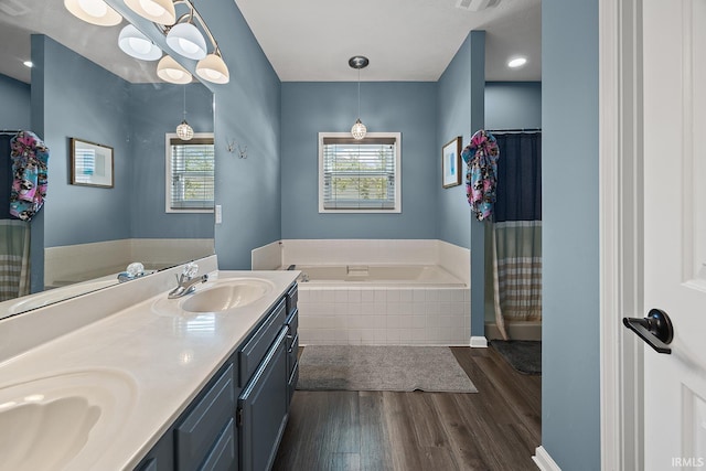 1709 Stonegate Cir, Lafayette, IN 47909 - bathroom featuring a bath, healthy amount of natural light, wood finished floors, and double vanity
