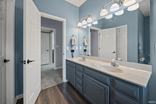 1709 Stonegate Cir, Lafayette, IN 47909 - bathroom with double vanity, wood finished floors, and a chandelier