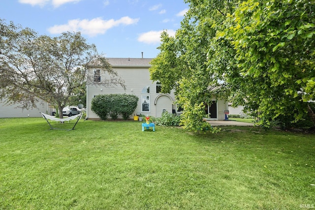 1709 Stonegate Cir, Lafayette, IN 47909 - view of green lawn featuring a patio area