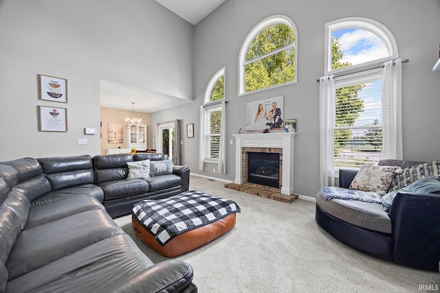 1709 Stonegate Cir, Lafayette, IN 47909 - living room featuring a chandelier, carpet, a towering ceiling, and a fireplace