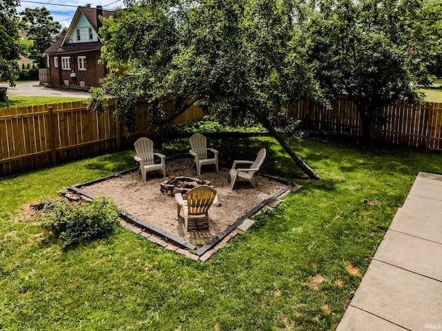 725 E Jackson St, Muncie, IN 47305 - fenced backyard featuring a fire pit and a patio area