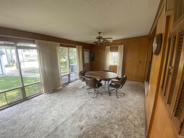 1415 Virginia St, Lafayette, IN 47905 - carpeted dining room featuring ceiling fan and wood walls