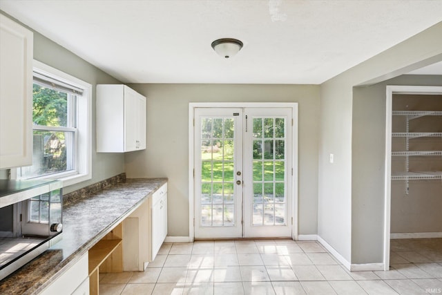 55310 Moss Rd, South Bend, IN 46628 - kitchen with white cabinetry, french doors, and light tile patterned floors
