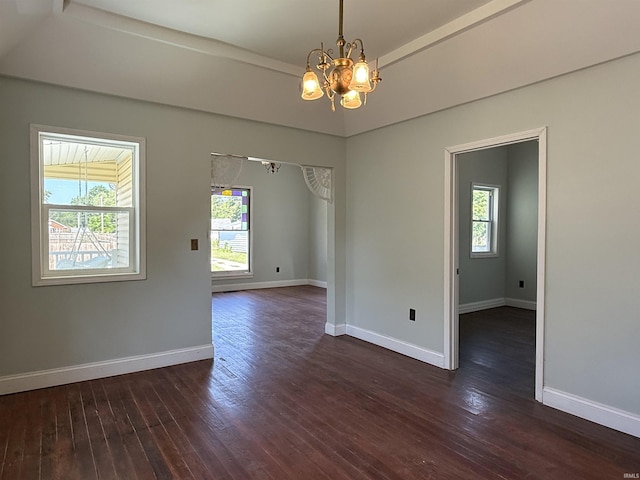 712 N Lindsay St, Kokomo, IN 46901 - unfurnished room featuring a chandelier and dark wood-type flooring