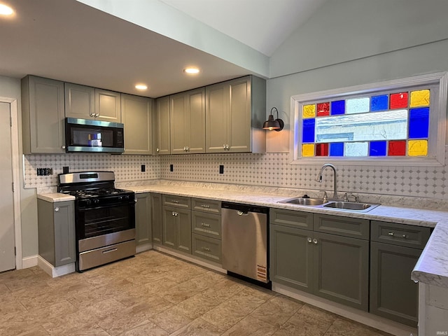 712 N Lindsay St, Kokomo, IN 46901 - kitchen with stainless steel appliances, gray cabinets, tasteful backsplash, vaulted ceiling, and recessed lighting