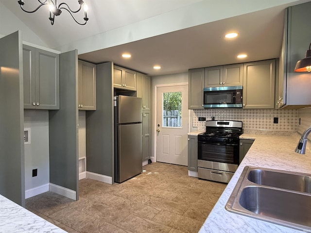 712 N Lindsay St, Kokomo, IN 46901 - kitchen with appliances with stainless steel finishes, light countertops, backsplash, a chandelier, and recessed lighting