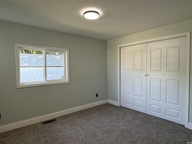 712 N Lindsay St, Kokomo, IN 46901 - unfurnished bedroom featuring dark colored carpet and a closet