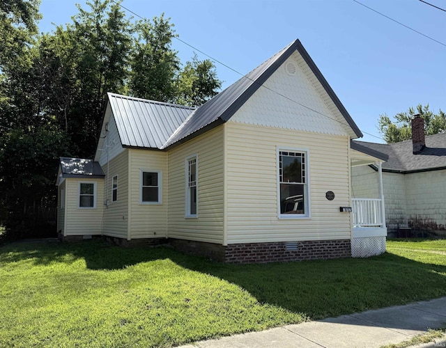 712 N Lindsay St, Kokomo, IN 46901 - view of property exterior featuring crawl space, a yard, and a metal roof