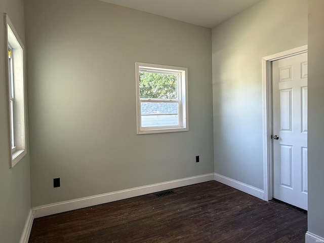 712 N Lindsay St, Kokomo, IN 46901 - empty room with dark wood finished floors and baseboards
