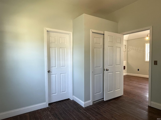 712 N Lindsay St, Kokomo, IN 46901 - unfurnished bedroom featuring dark wood-style flooring