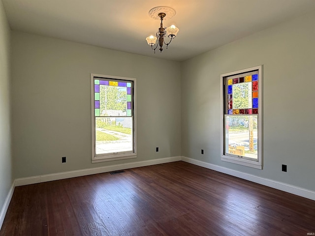 712 N Lindsay St, Kokomo, IN 46901 - unfurnished room with a chandelier and dark wood-style flooring