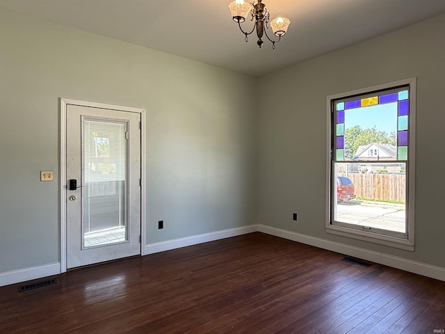 712 N Lindsay St, Kokomo, IN 46901 - unfurnished room featuring healthy amount of natural light, a chandelier, and dark wood finished floors