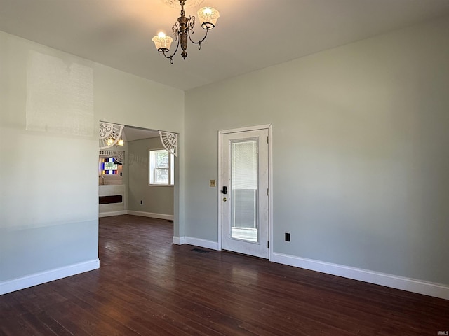 712 N Lindsay St, Kokomo, IN 46901 - spare room with a chandelier and dark wood-style floors