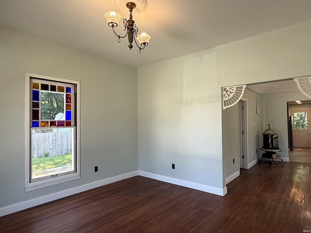 712 N Lindsay St, Kokomo, IN 46901 - empty room featuring dark wood-style flooring and a chandelier