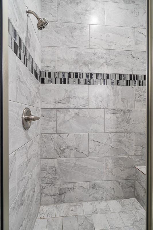 bathroom with a tile shower