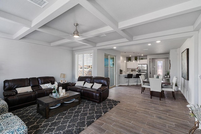 living room featuring wood-type flooring, ceiling fan, coffered ceiling, and beam ceiling