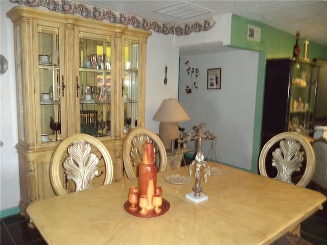 dining room with a textured ceiling