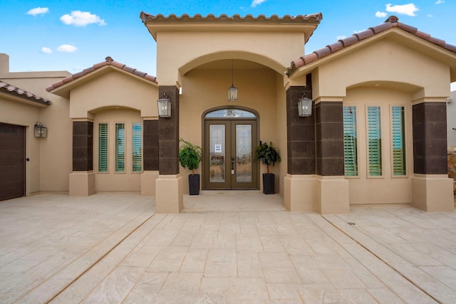2425 Cesar Cordova Pl, El Paso, TX 79938 - view of exterior entry with a garage and french doors