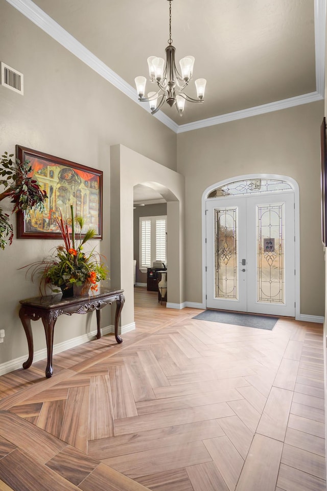 2425 Cesar Cordova Pl, El Paso, TX 79938 - entryway with light parquet flooring, a chandelier, crown molding, and french doors