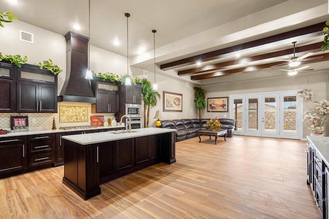 2425 Cesar Cordova Pl, El Paso, TX 79938 - kitchen featuring light hardwood / wood-style floors, decorative light fixtures, beam ceiling, ceiling fan, and custom range hood