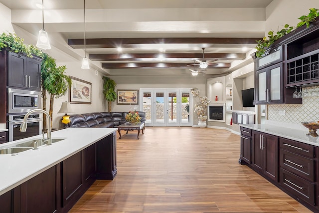 2425 Cesar Cordova Pl, El Paso, TX 79938 - kitchen featuring ceiling fan, appliances with stainless steel finishes, beamed ceiling, backsplash, and decorative light fixtures