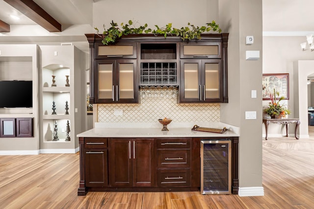 2425 Cesar Cordova Pl, El Paso, TX 79938 - bar with light wood-type flooring, beam ceiling, wine cooler, dark brown cabinets, and light stone countertops