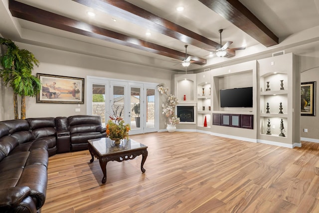 2425 Cesar Cordova Pl, El Paso, TX 79938 - living room featuring ceiling fan, beamed ceiling, light wood-type flooring, built in features, and french doors